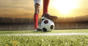 Jogador de futebol sobre a grama sintética padrão FIFA